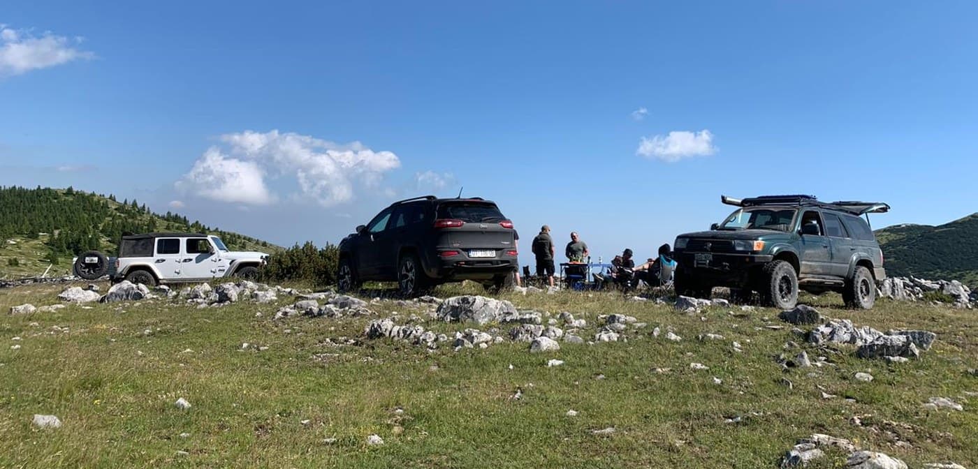 Overlanders at a Kosovo mountain summit